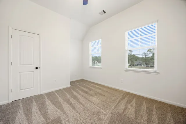 a view of an empty room with windows