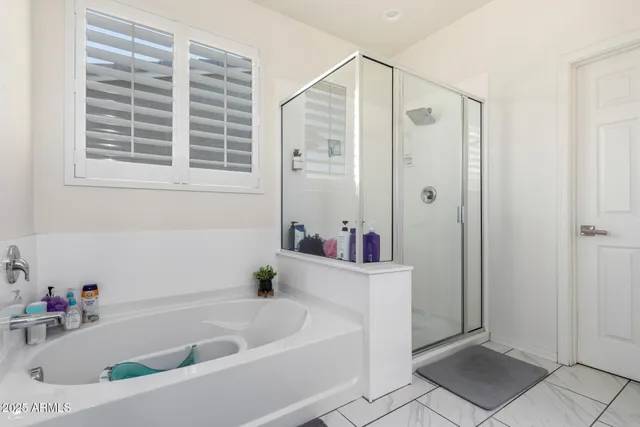 a bathroom with a bathtub and a shower
