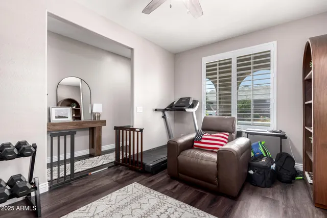 a bedroom with bed and wooden floor