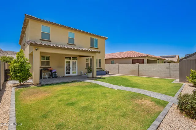 a view of a house with pool and a yard