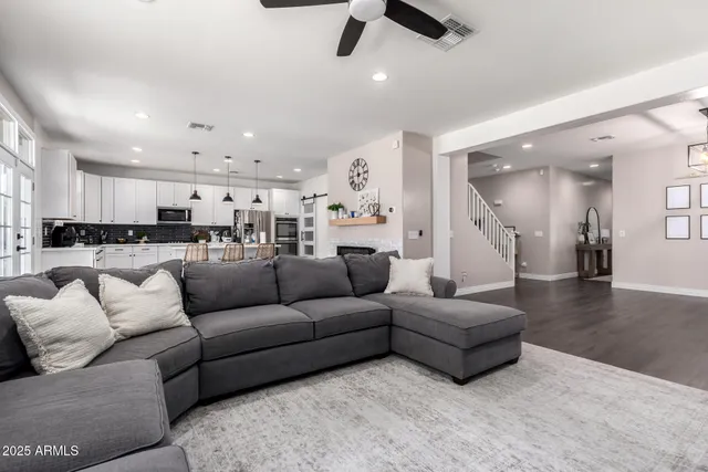 a living room with furniture and kitchen view