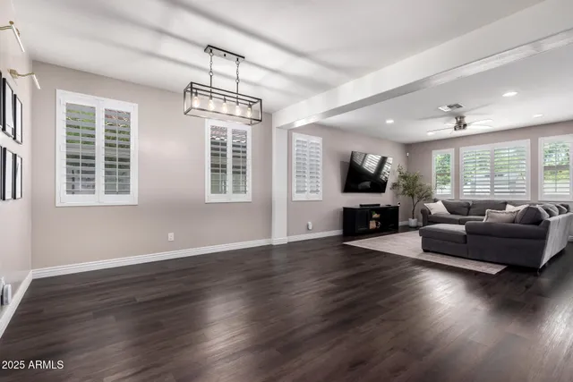 a living room with furniture wooden floor and a window