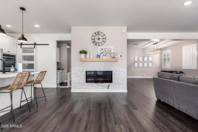 a living room with furniture a fireplace and wooden floor