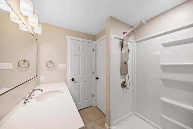 a view of a balcony with wooden floor and fence