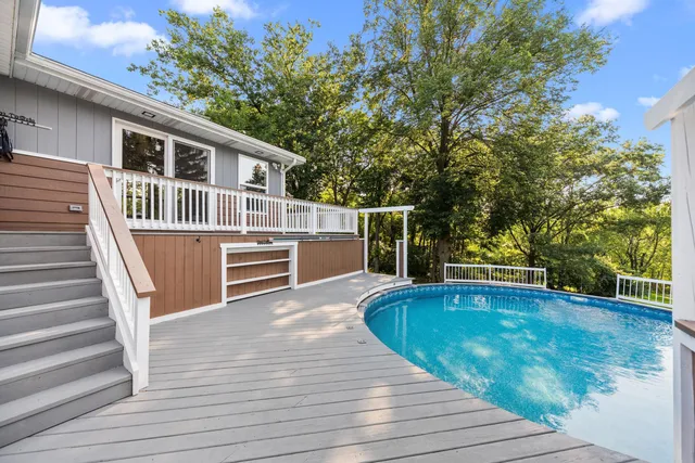 a view of green field with a tree in the background