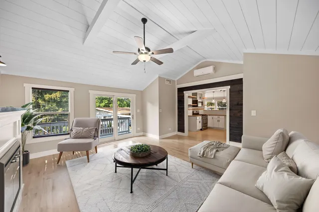 a large kitchen with stainless steel appliances and white cabinets