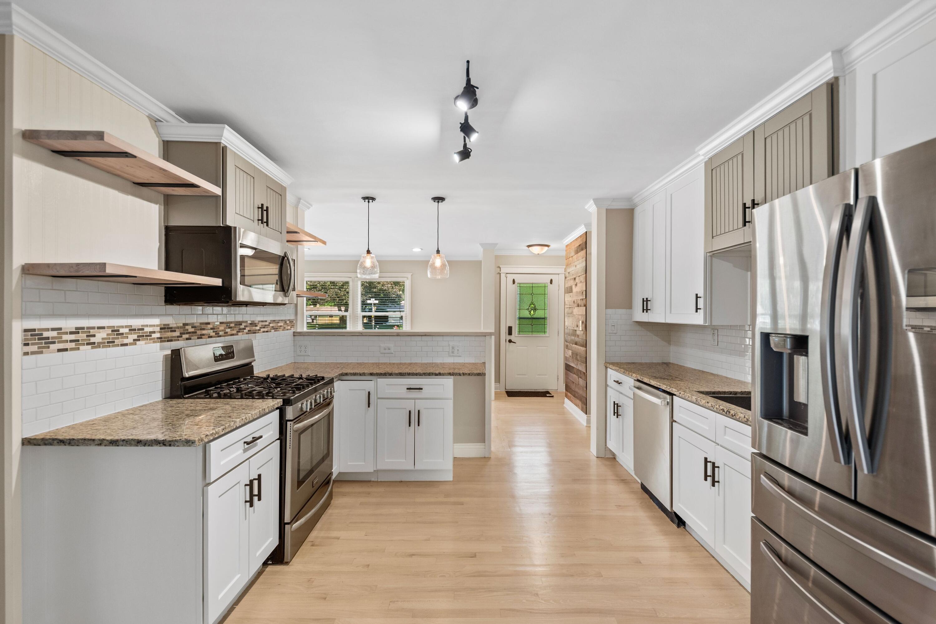 9176 West Springhill Drive St. John, IN 46373 - Photo 8 of 20 a large kitchen with stainless steel appliances and white cabinets