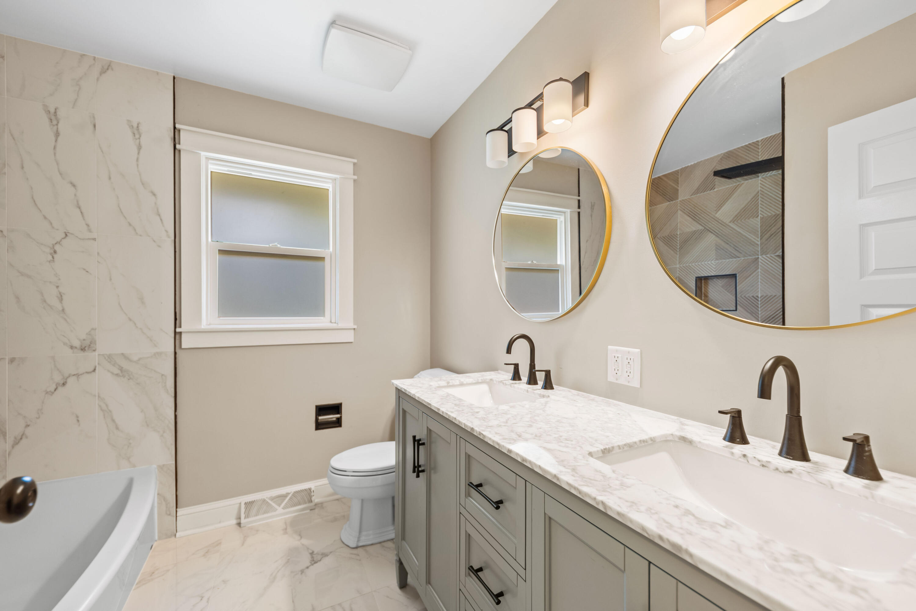 9176 West Springhill Drive St. John, IN 46373 - Photo 10 of 20 a bathroom with a double vanity sink mirror and a