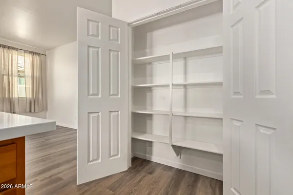a view of walk in closet with empty racks