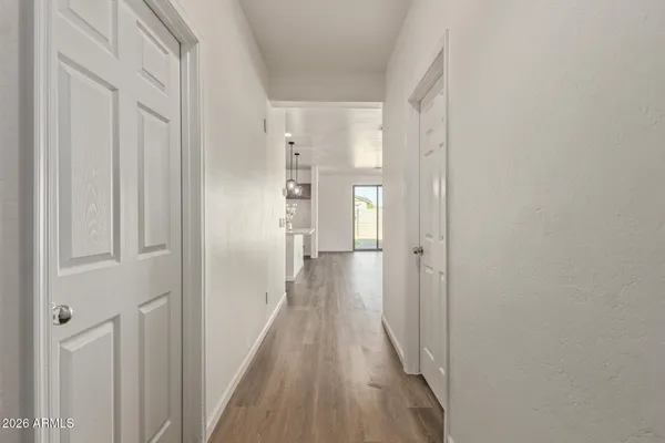 a view of a room with wooden floor