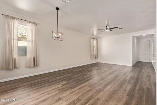 a view of a room with wooden floor and window
