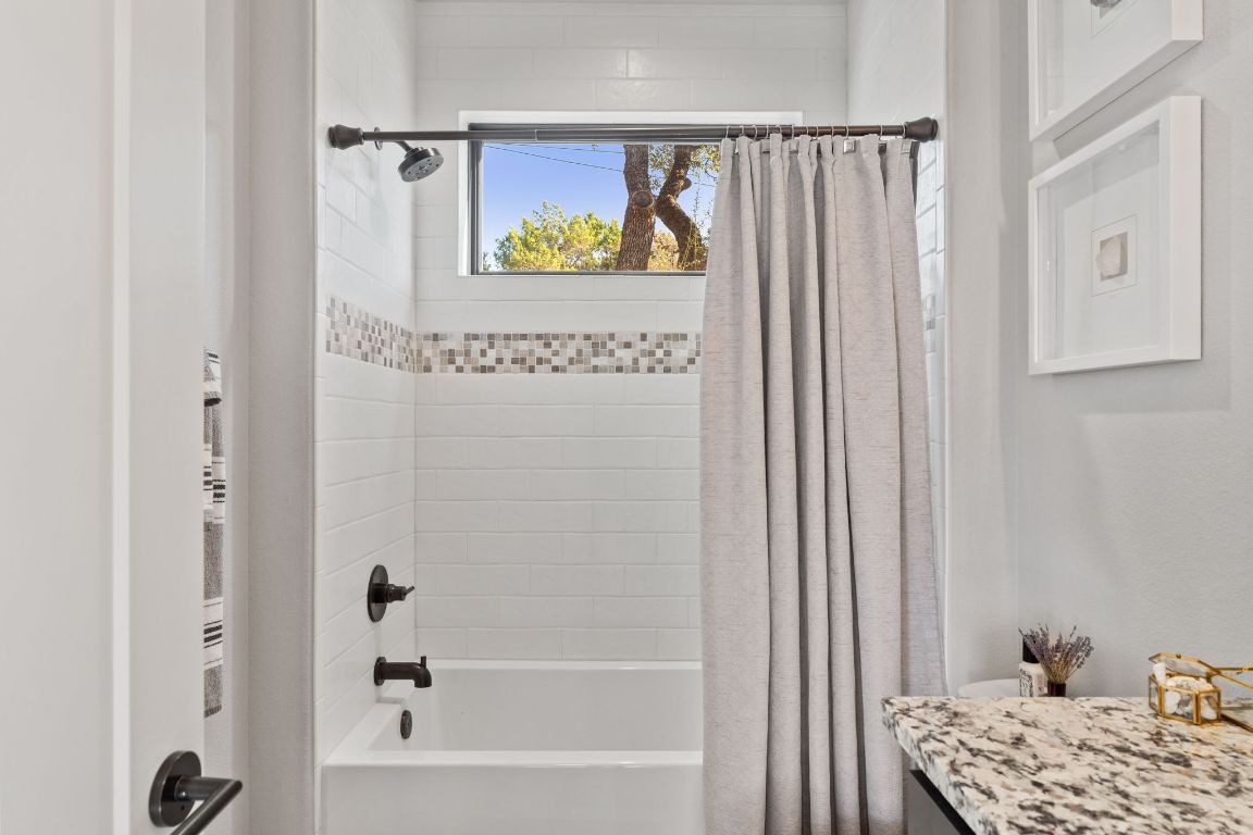 418 Summit Ridge Drive North Lago Vista, TX 78645 - Photo 11 of 40 a bathroom with a bathtub and a window