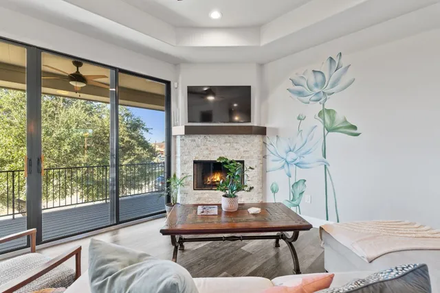 a living room with furniture a flat screen tv and a fireplace