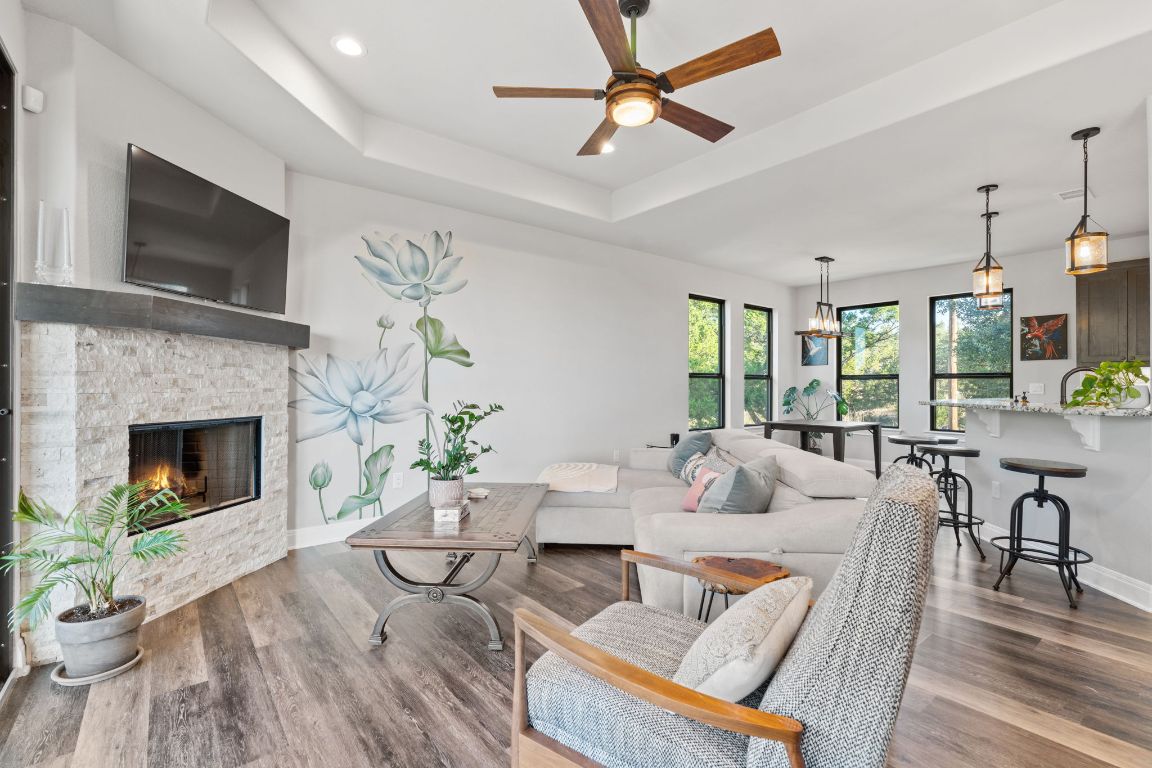 418 Summit Ridge Drive North Lago Vista, TX 78645 - Photo 18 of 40 a living room with furniture a flat screen tv and a fireplace