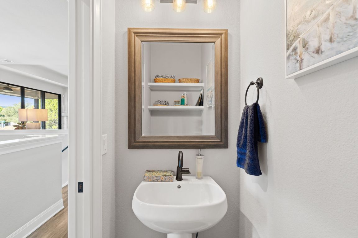 418 Summit Ridge Drive North Lago Vista, TX 78645 - Photo 21 of 40 a bathroom with a sink and a mirror