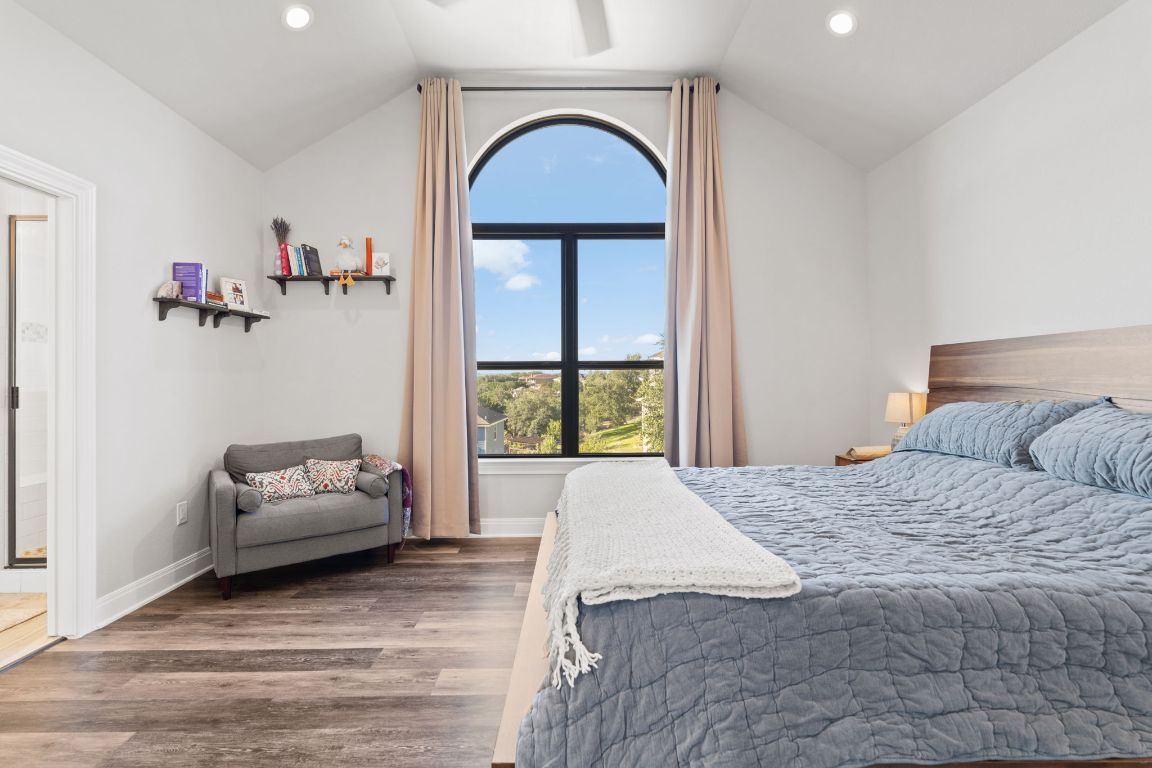 418 Summit Ridge Drive North Lago Vista, TX 78645 - Photo 23 of 40 a bedroom with a bed and a window