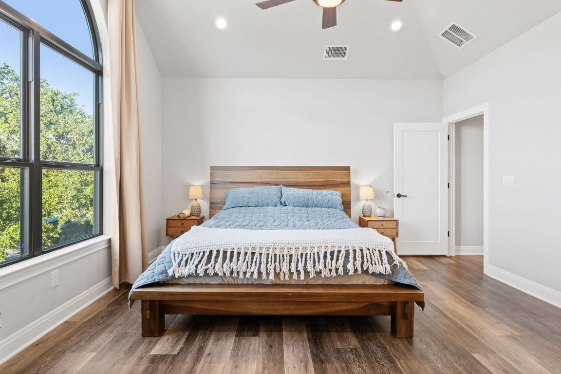 418 Summit Ridge Drive North Lago Vista, TX 78645 - Photo 25 of 40 a bedroom with a bed and wooden floor