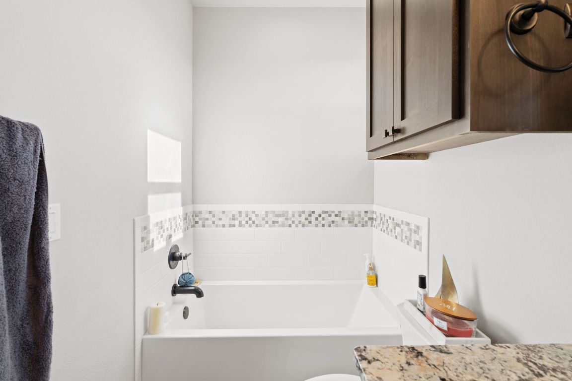 418 Summit Ridge Drive North Lago Vista, TX 78645 - Photo 28 of 40 a bathroom with a bathtub and a shower