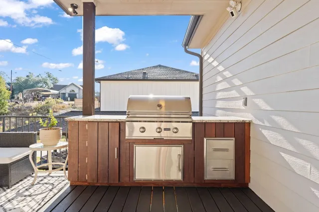 a balcony with furniture and a potted plant