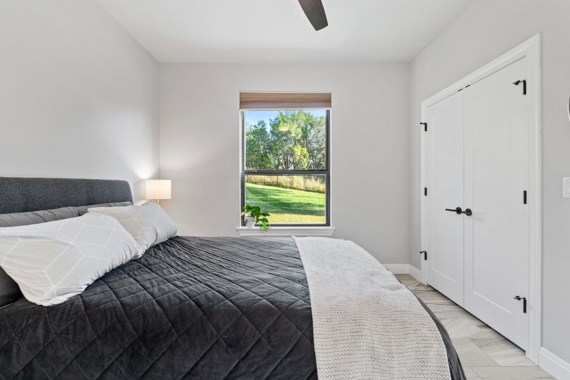 418 Summit Ridge Drive North Lago Vista, TX 78645 - Photo 7 of 40 a bedroom with a bed and a window