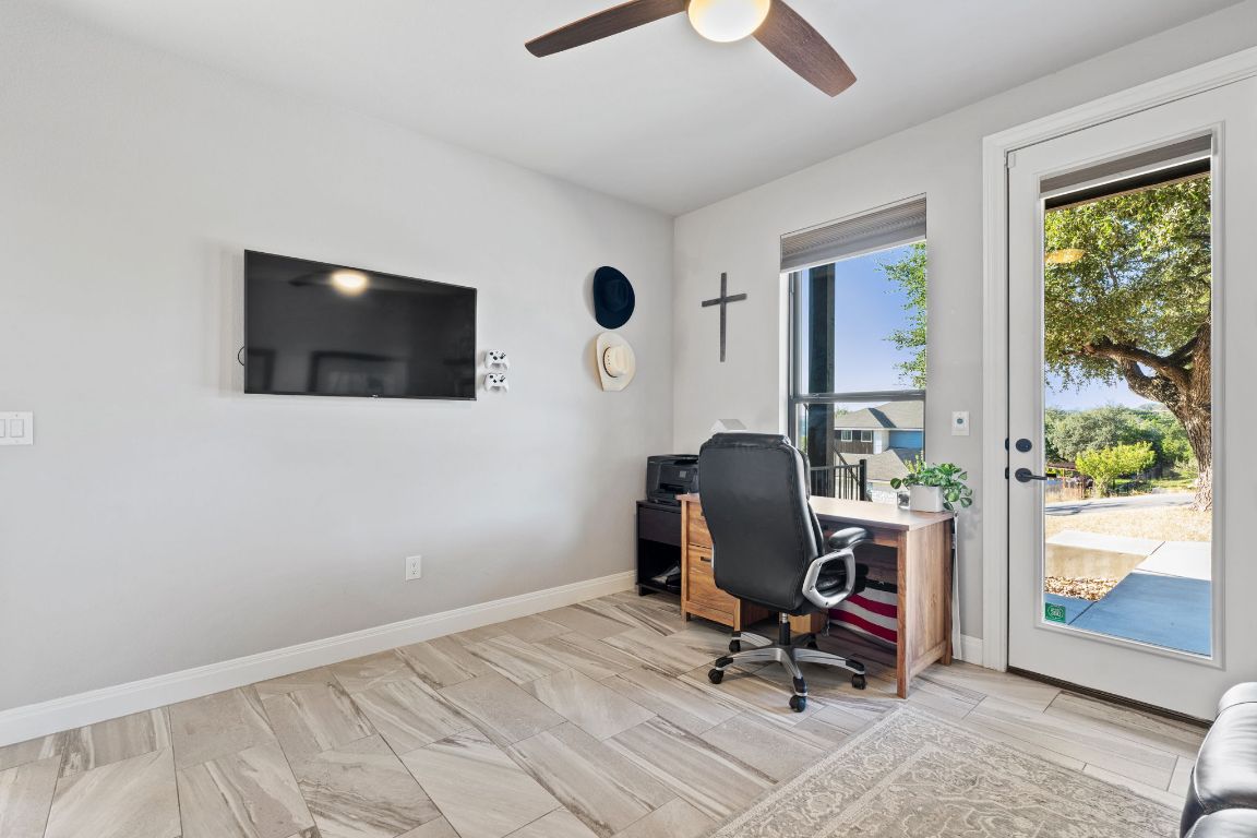 418 Summit Ridge Drive North Lago Vista, TX 78645 - Photo 9 of 40 a view of a workspace with furniture and a window