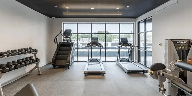 a room with gym equipment and a large window