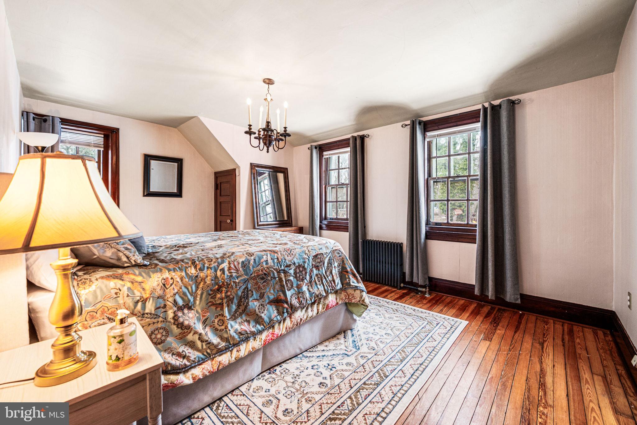1018 Beech Road Wallingford, PA 19086 - Photo 58 of 66 a bedroom with a bed and wooden floor