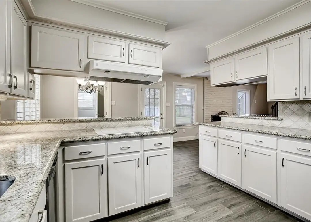 11426 Cold Spring Drive Houston, TX 77043 - Photo 2 of 7 a kitchen with granite countertop white cabinets and a sink