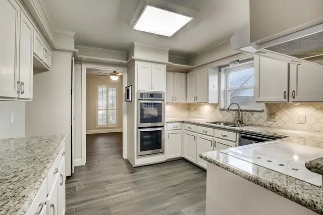 a kitchen with granite countertop stainless steel appliances and wooden cabinets