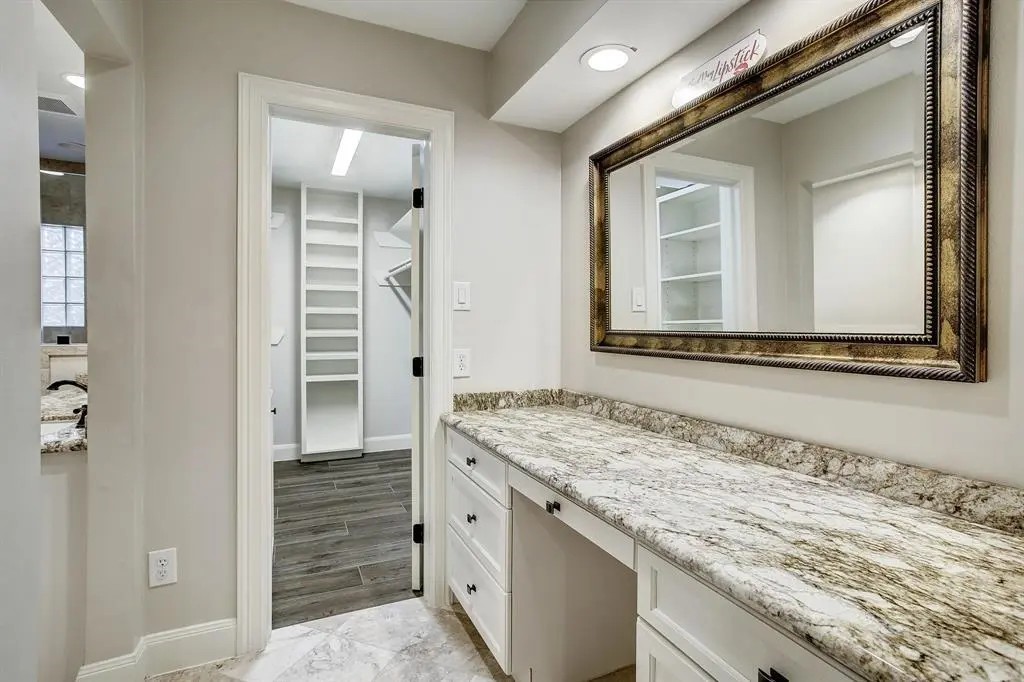 11426 Cold Spring Drive Houston, TX 77043 - Photo 5 of 7 a bathroom with a granite countertop sink and a mirror