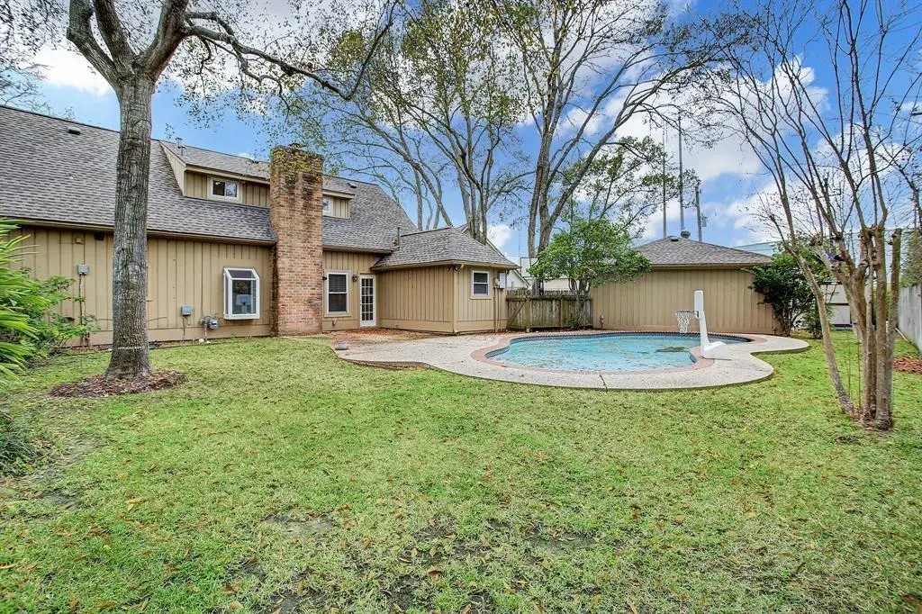 11426 Cold Spring Drive Houston, TX 77043 - Photo 7 of 7 a view of a house with a backyard and a tree