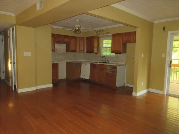 a view of a kitchen with a sink and a stove top oven