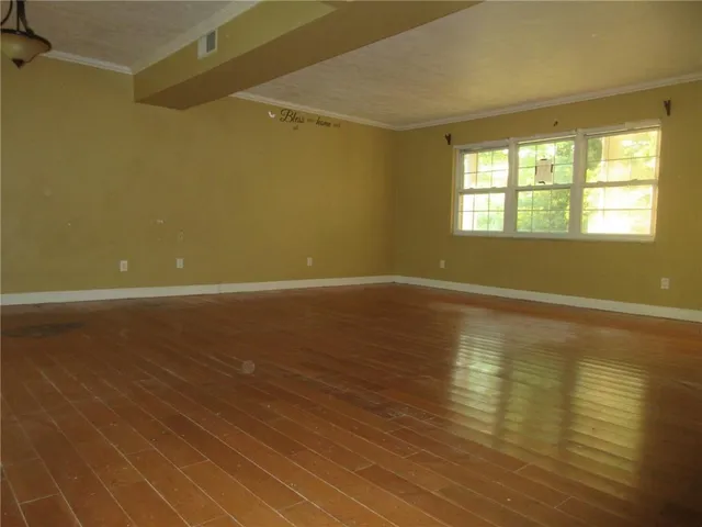 a view of room with window and wooden floor