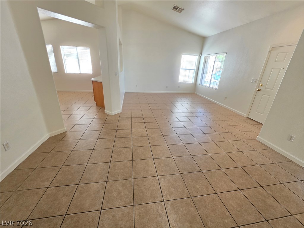 9609 Crystal Ridge Road Las Vegas, NV 89123 - Photo 6 of 21 Gleaming tile floors and vaulted ceilings define this airy, open-concept living space.