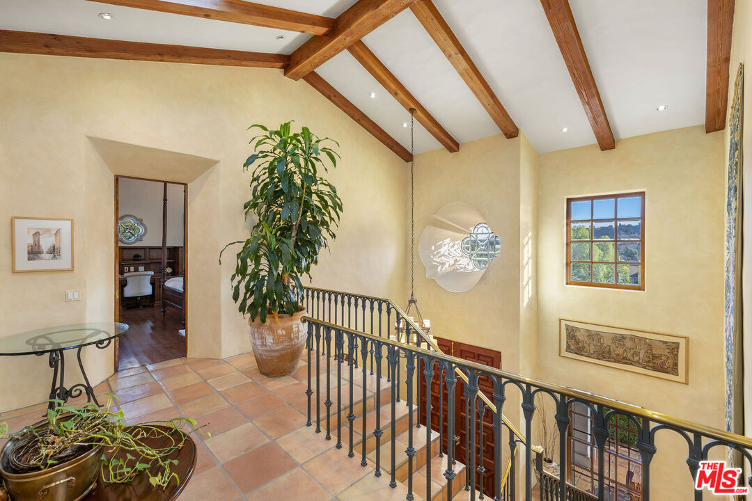 25127 Jim Bridger Road Hidden Hills, CA 91302 - Photo 21 of 50 a bedroom with furniture and a window