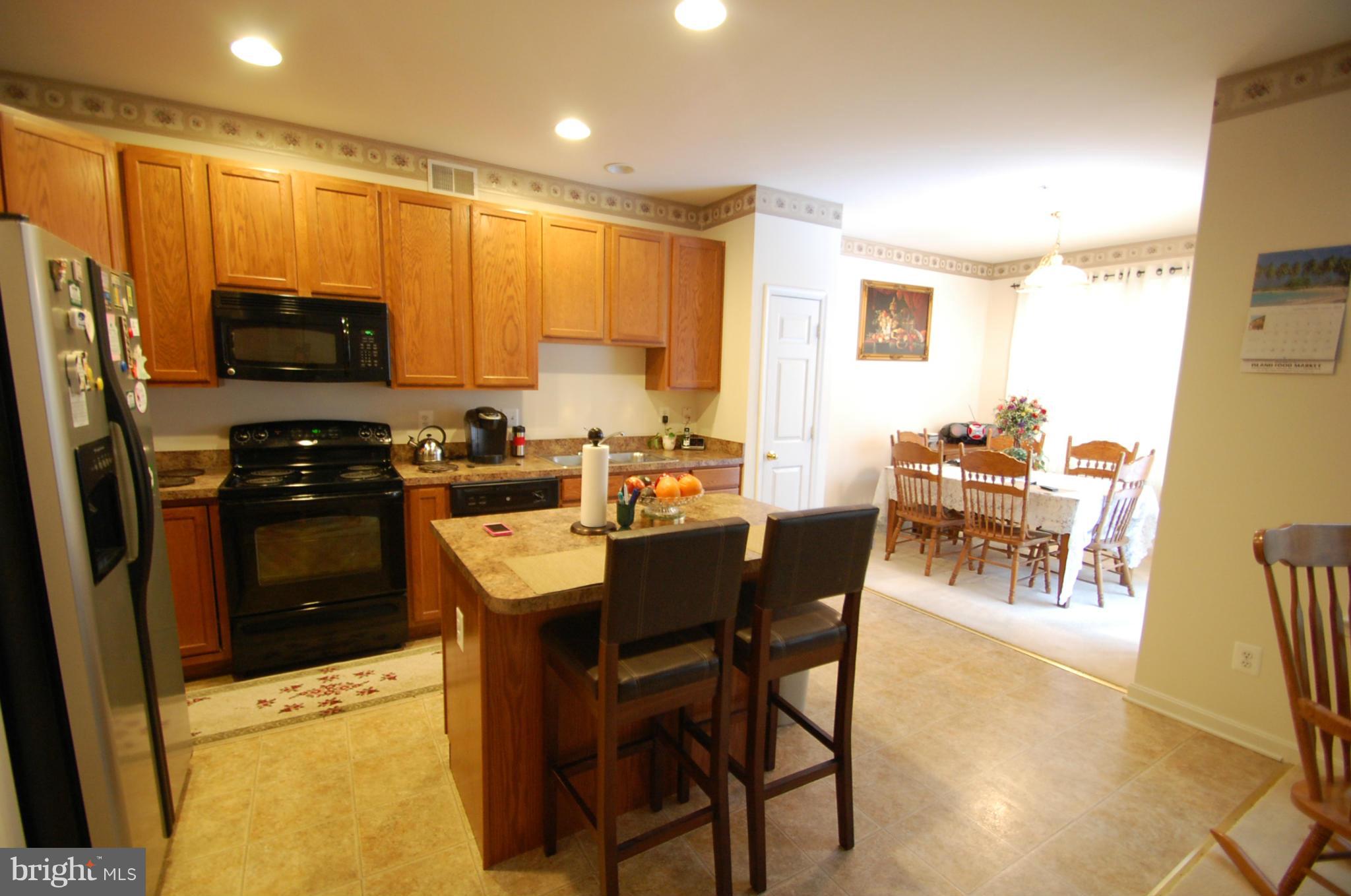 1954 Waltman Road Edgewood, MD 21040 - Photo 6 of 11 a kitchen with a table chairs refrigerator and cabinets