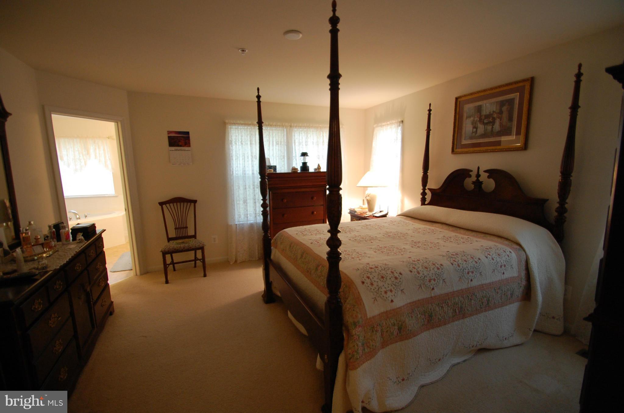 1954 Waltman Road Edgewood, MD 21040 - Photo 7 of 11 a bedroom with a bed a dresser and a flat screen tv