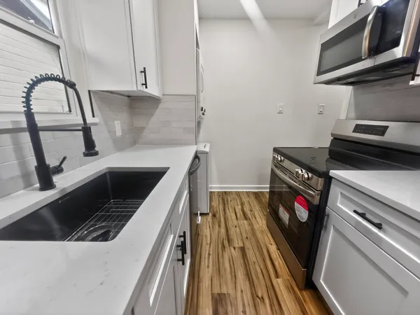 a kitchen with a stove and a sink