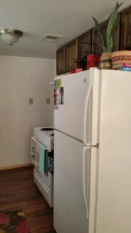 a white refrigerator freezer sitting inside of a kitchen