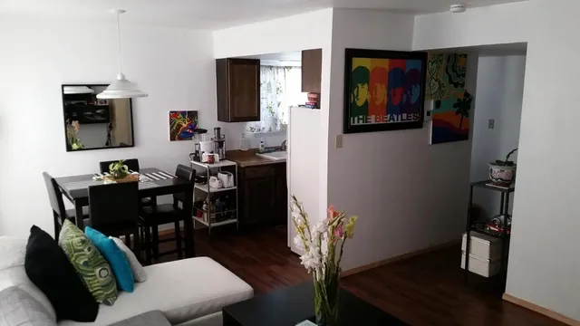 a view of a dining room with furniture and wooden floor