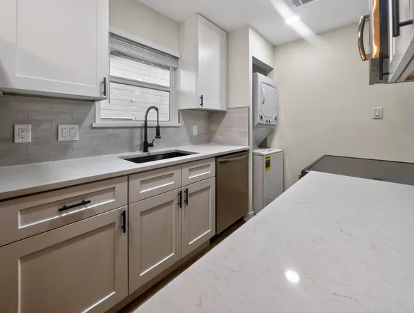 a kitchen with a sink cabinets and appliances