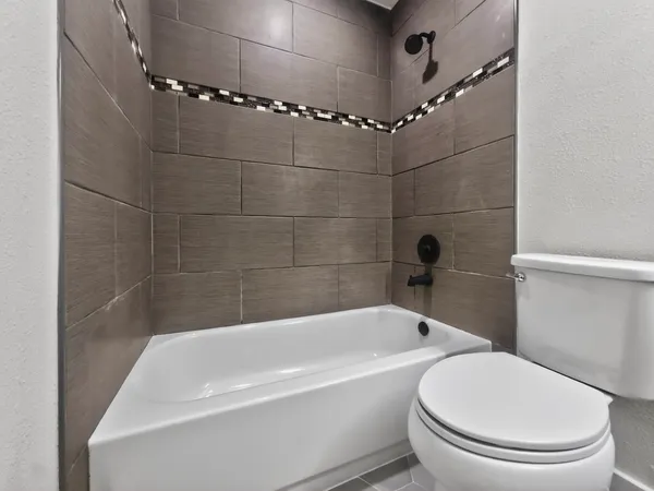 a white bath tub sitting next to a white toilet