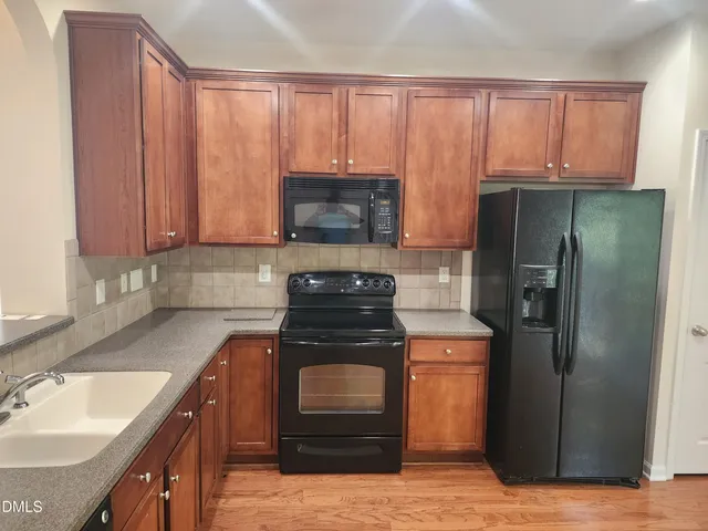 a kitchen with a stove and a refrigerator