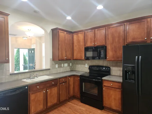 a kitchen with a sink stove and microwave