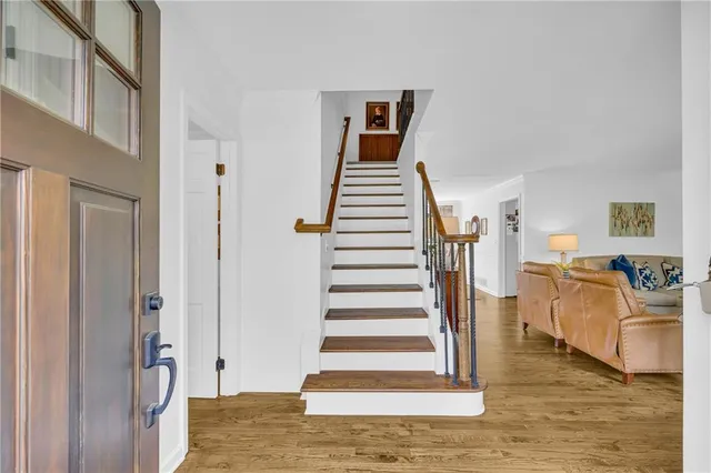 a view of a dining room with furniture a chandelier and wooden floor