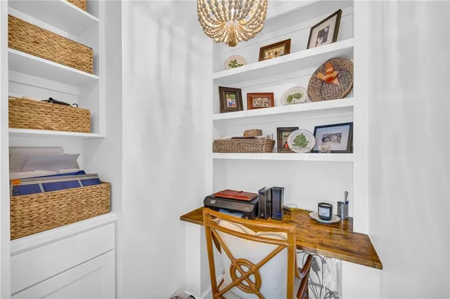 a bedroom with a bed and a lamp on dresser