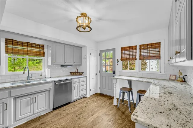 a bedroom with bed and a night lamp on table
