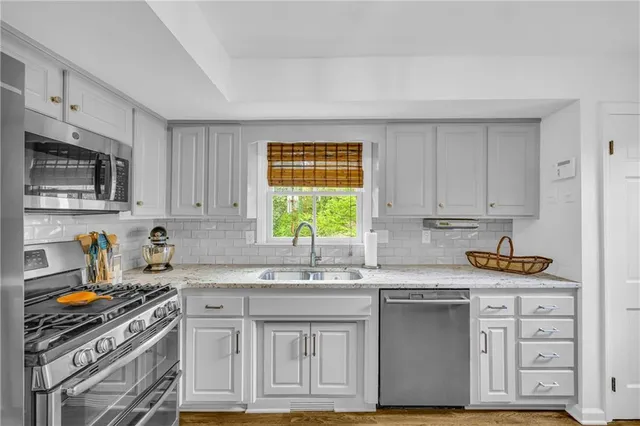 a bathroom with a sink vanity mirror and toilet