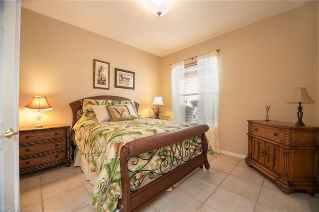 a bedroom with a bed and dresser