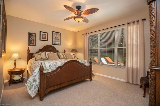 a bedroom with a bed and a ceiling fan